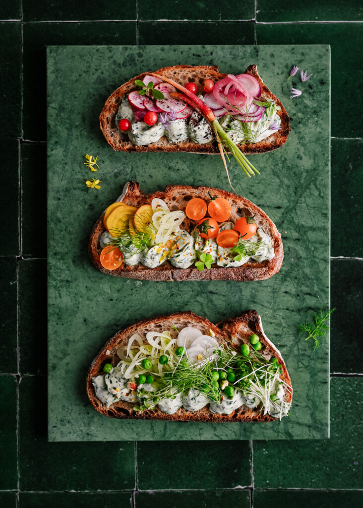 Smorrebrod toasts with vegan herb cream and veggies