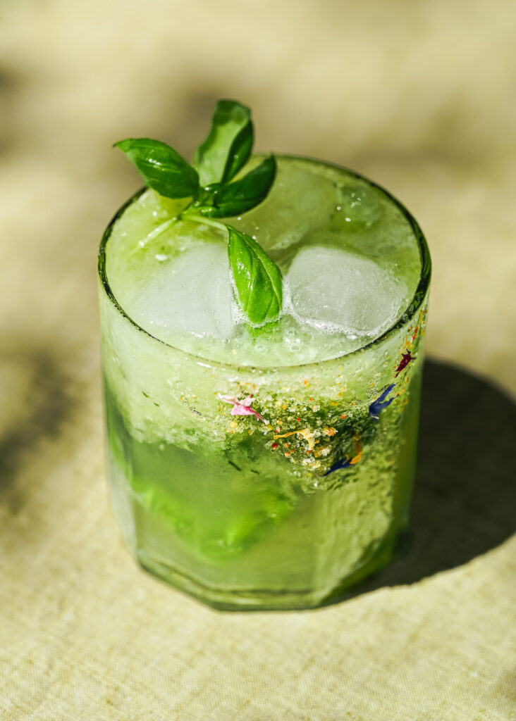 Zingy cucumber basil Mocktail with edible blossoms and chili salt