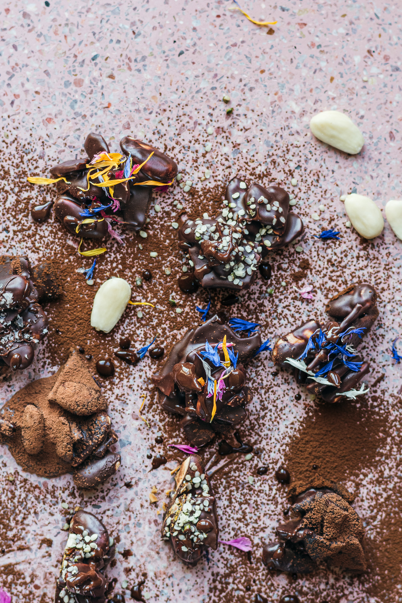 Almond, caramel chocoate crisps with edible blossoms and cacao dust