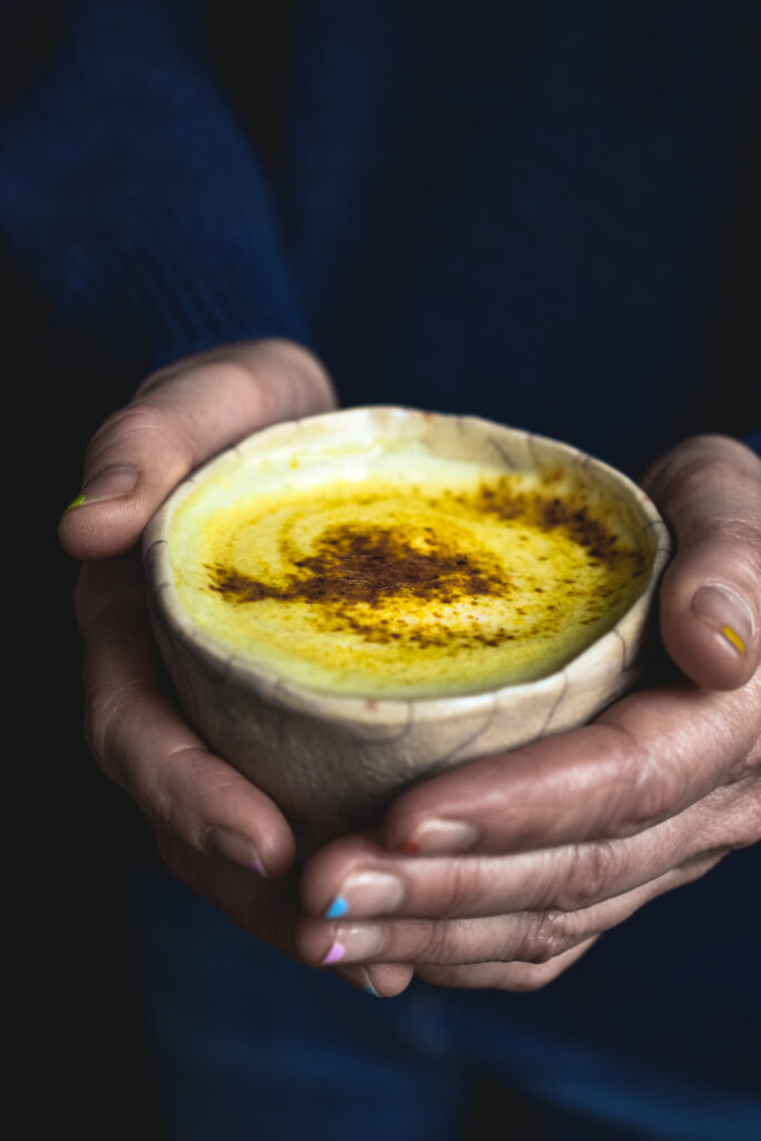 Golden milk holding in hands