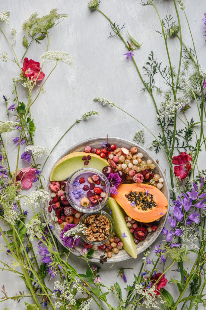 Fruit platter with granola, cashew cream and wild blossms