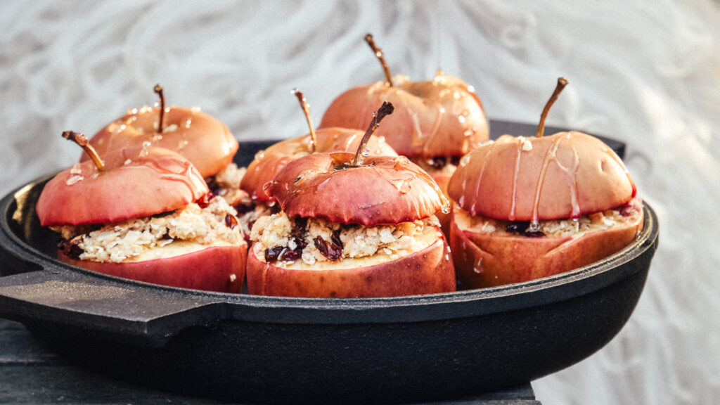 Baked apples with oat marzipan filling in cast iron pan