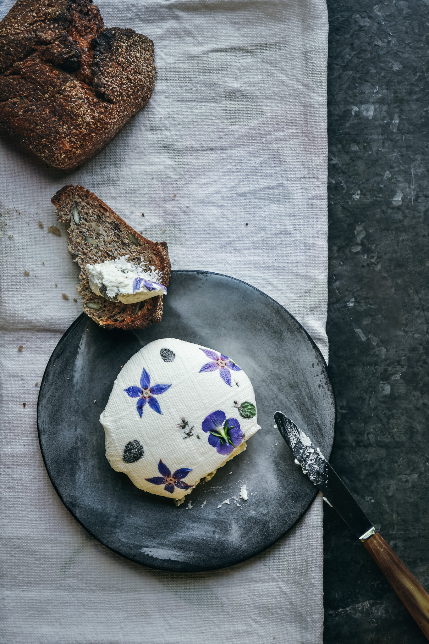 almond cheese with edible blossoms and seed bread