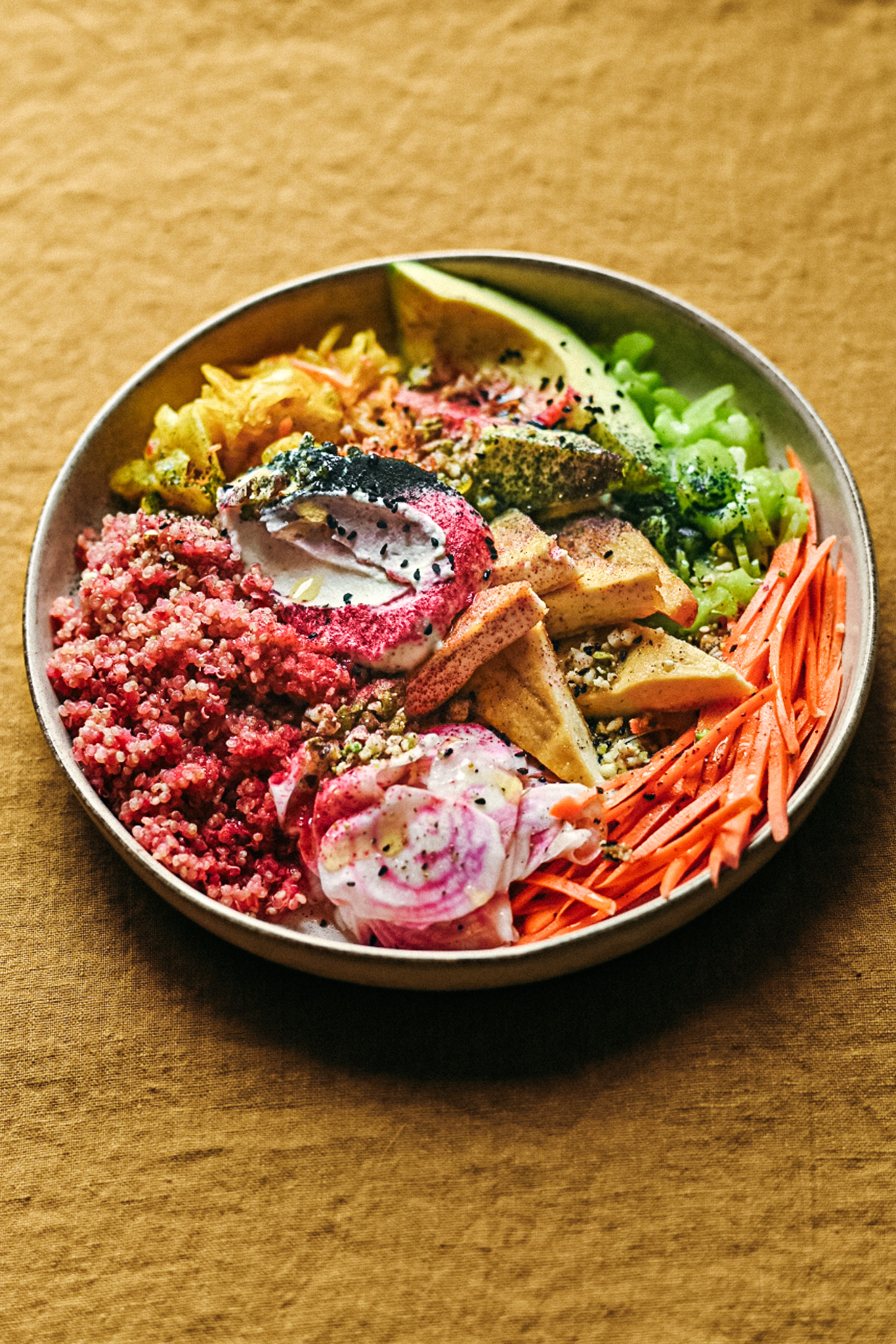 Poke bowl with raw veggies, japanese tofu, avocado and spirulina dust