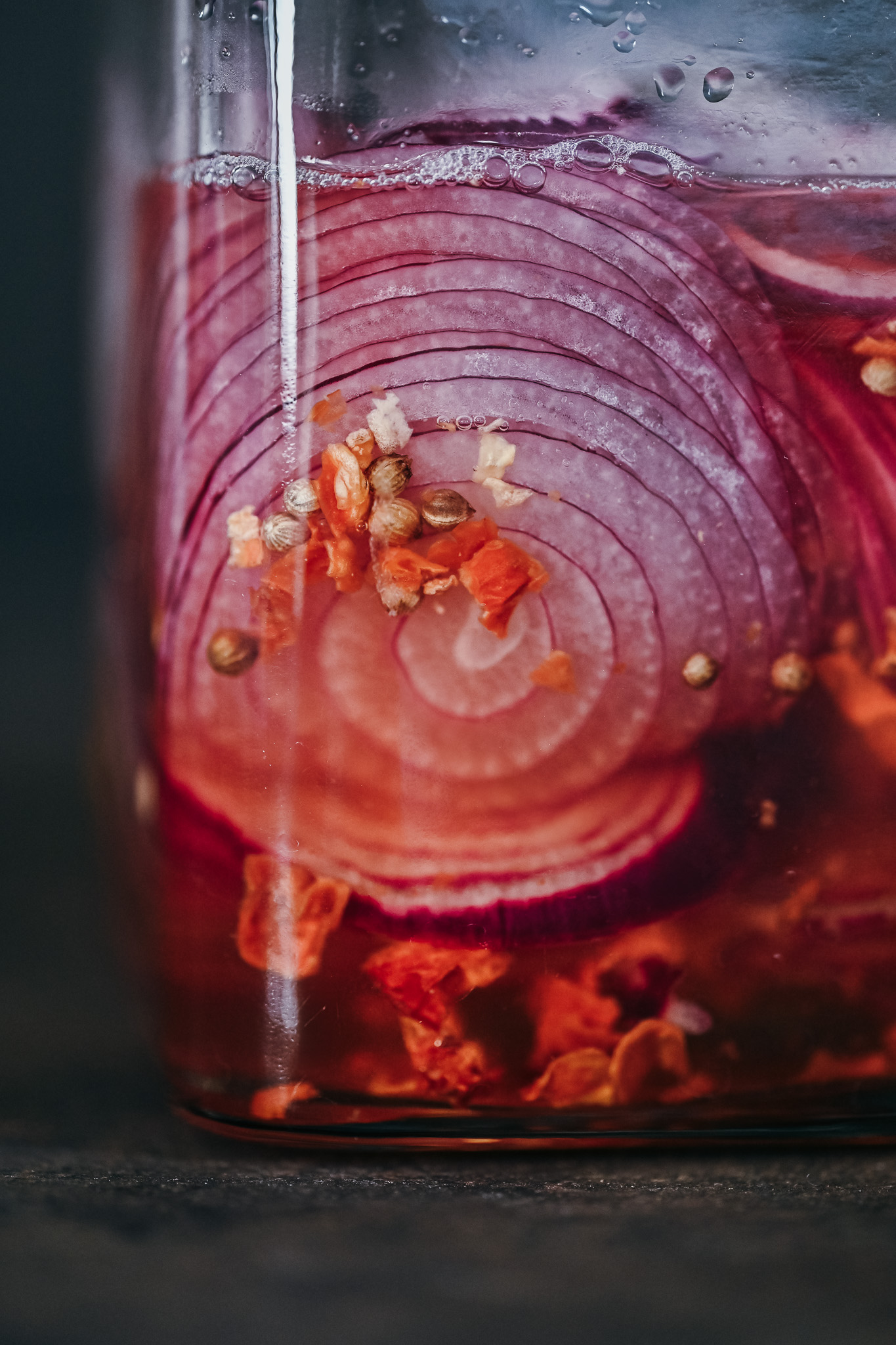 Pickled red onions with coriander seeds, chily and vinegar