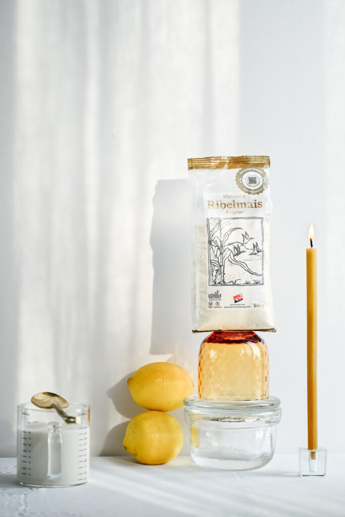 Stilllife with Ribelmais, lemon, plant milk and a candle