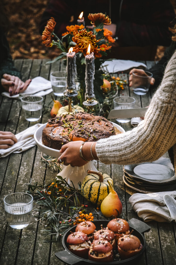 Serving persimmon cake to the autumnal decorated table