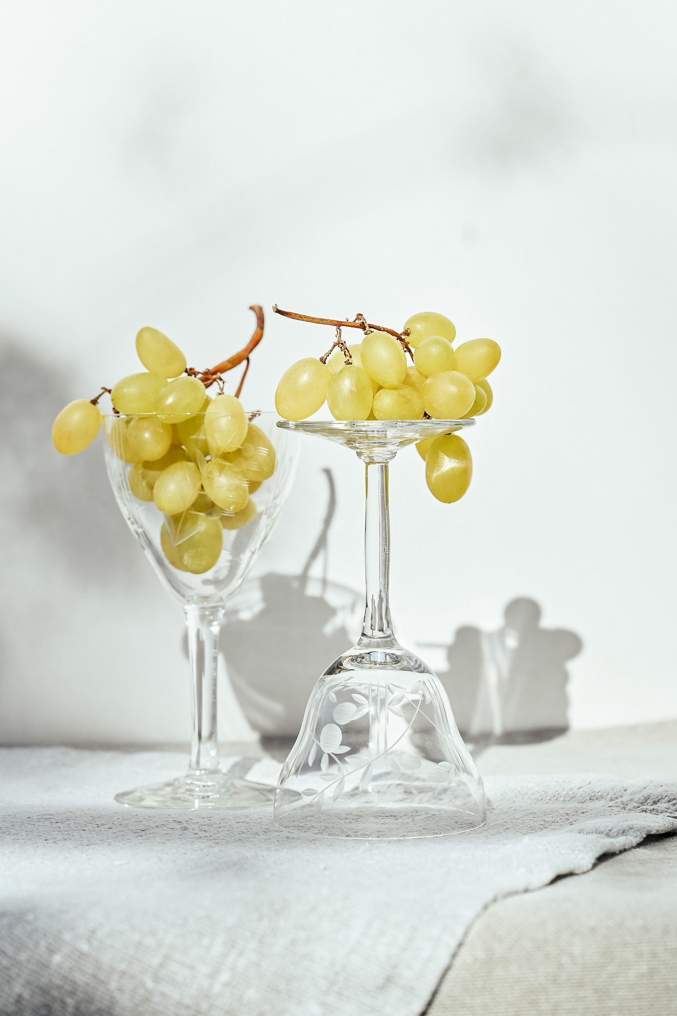 Vintage glasses with yellow grapes in sunlight