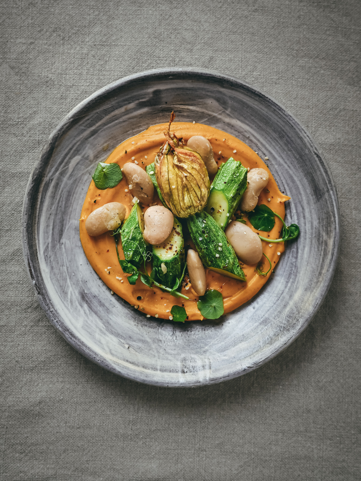 Zucchinin Flowers filled with vegan Ricotta, beans and pumpkin purée