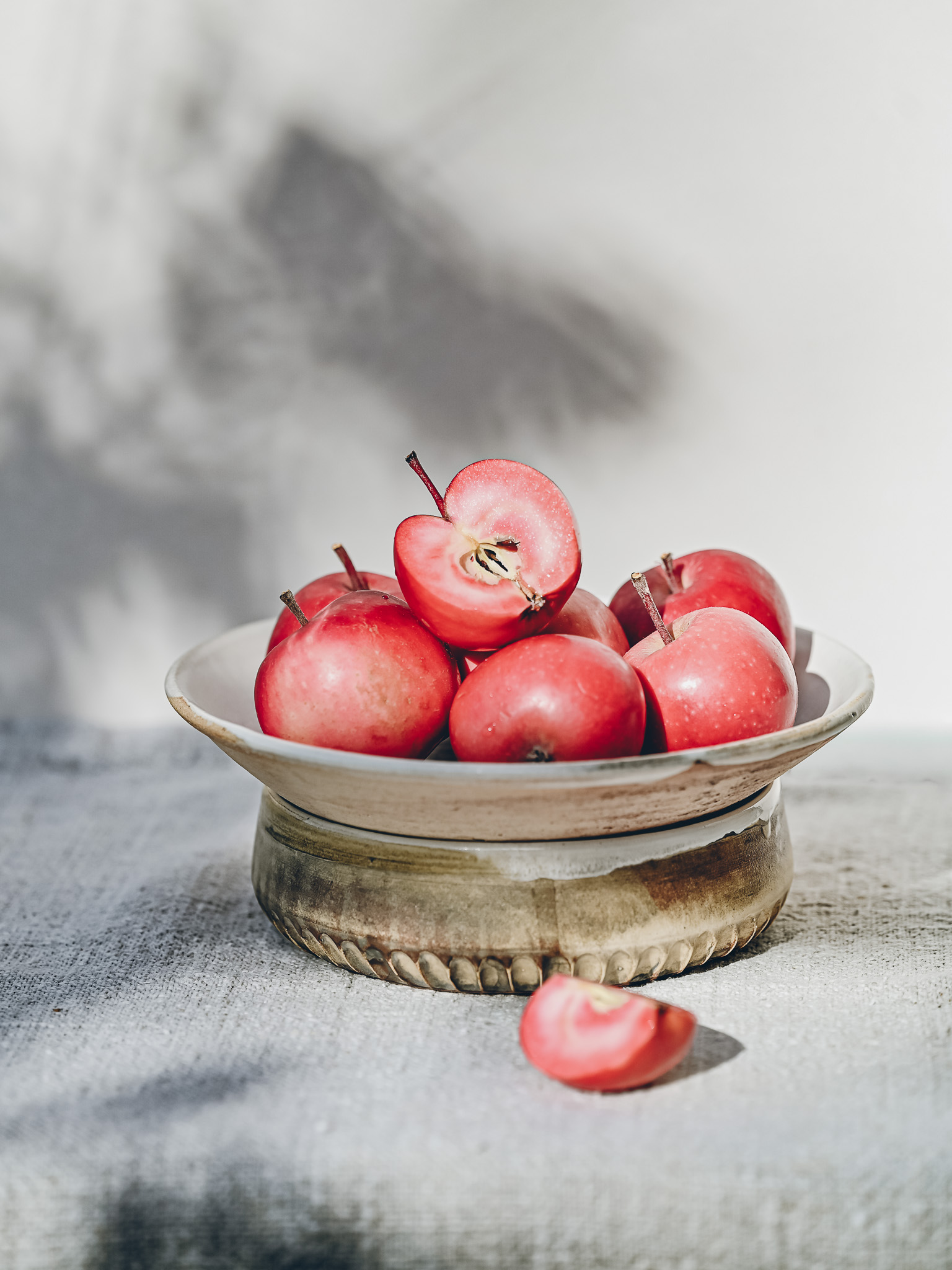 Red Love apples in a bowl by Tina Kami, shadow play